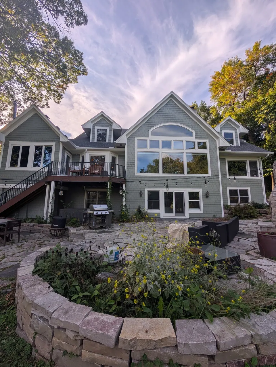 The rear of the Independence home, sage green shake siding with white trim